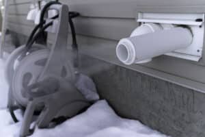 Steam coming out of furnace exhaust in winter with snow on ground